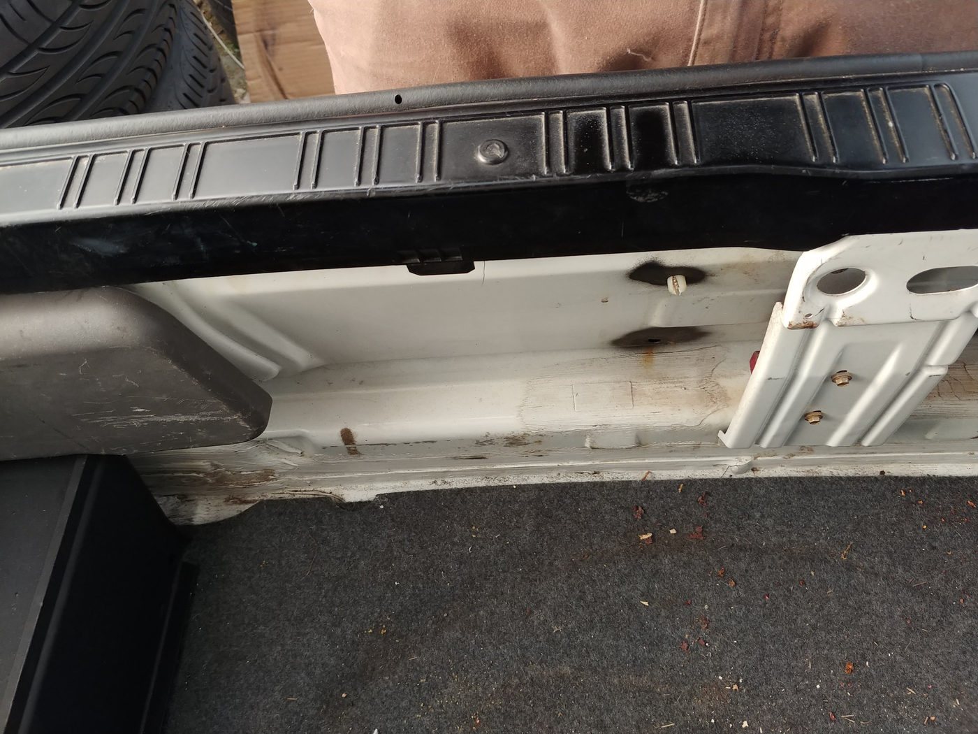 The rear panel of an E30 boot with the carpet panel removed, between the tail light openings